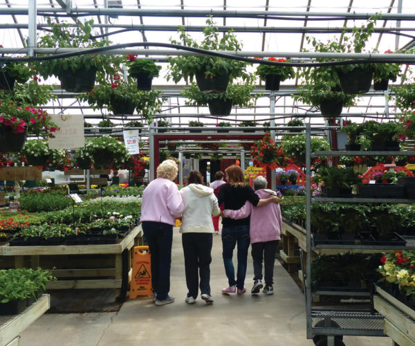 women touring a greenhouse