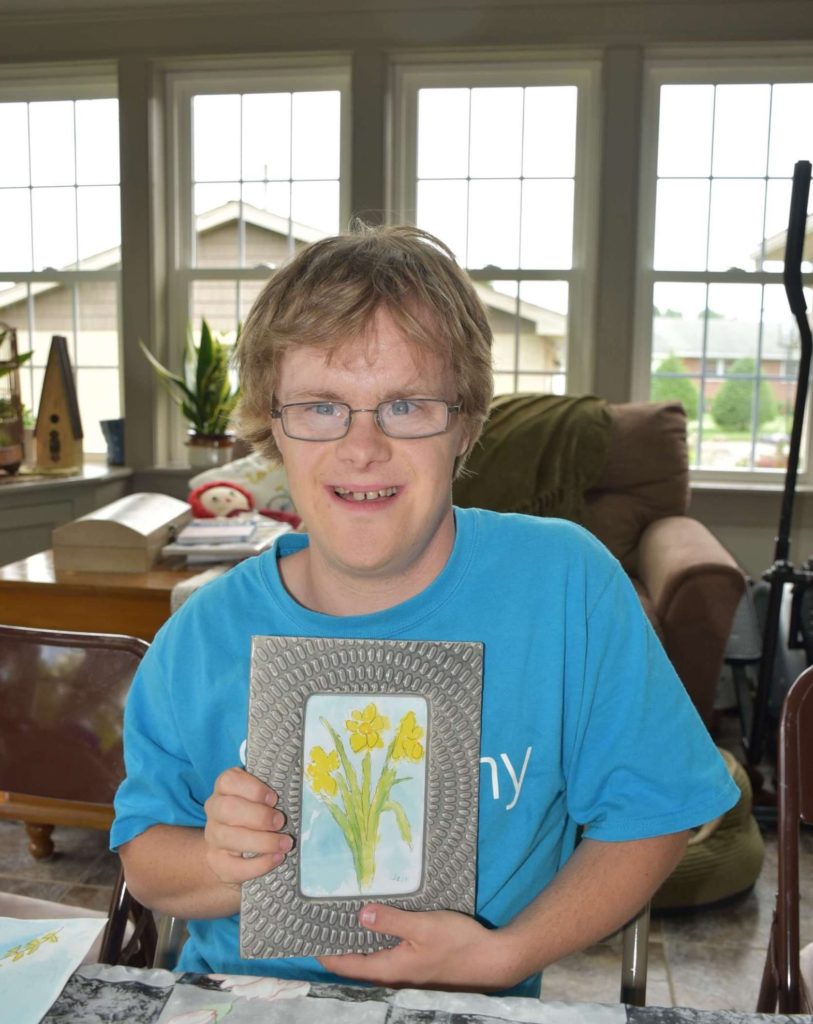 Josh with framed flowers