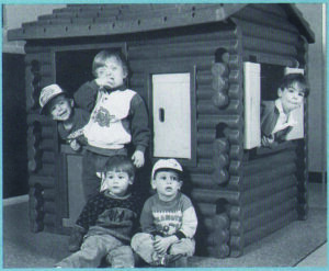 Logan as a child with UCP classroom friends